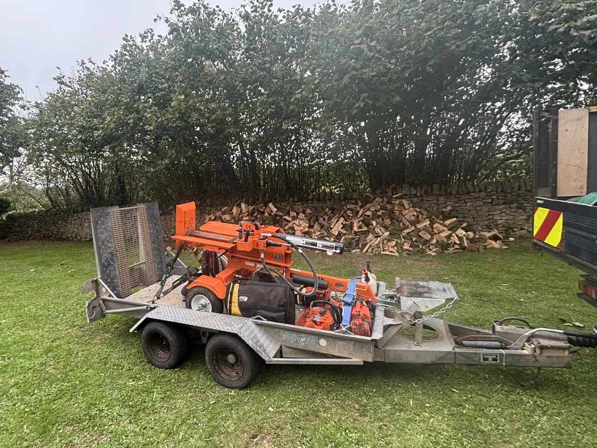 J.B Tree Surgery log splitter and equipment secured on a trailer